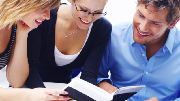 Three smiling people in a meeting