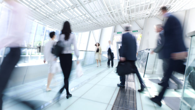 Blurred image of office workers walking
