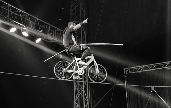 Man cycling on a tight rope
