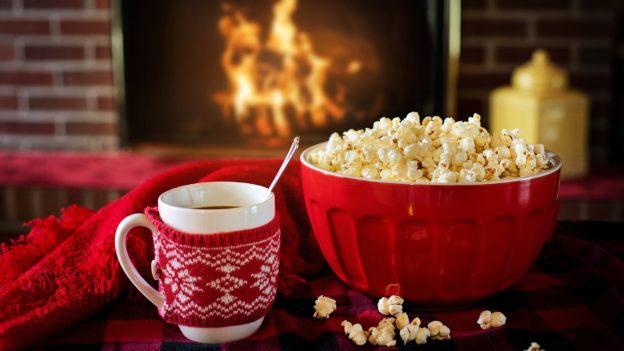 Mug and popcorn by a cosy fire