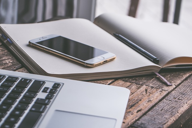 Laptop and a phone on a desk